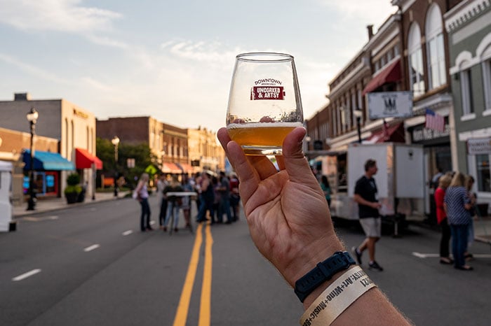 a small glass of beer from Uncorked in Artsy at a farmer's market