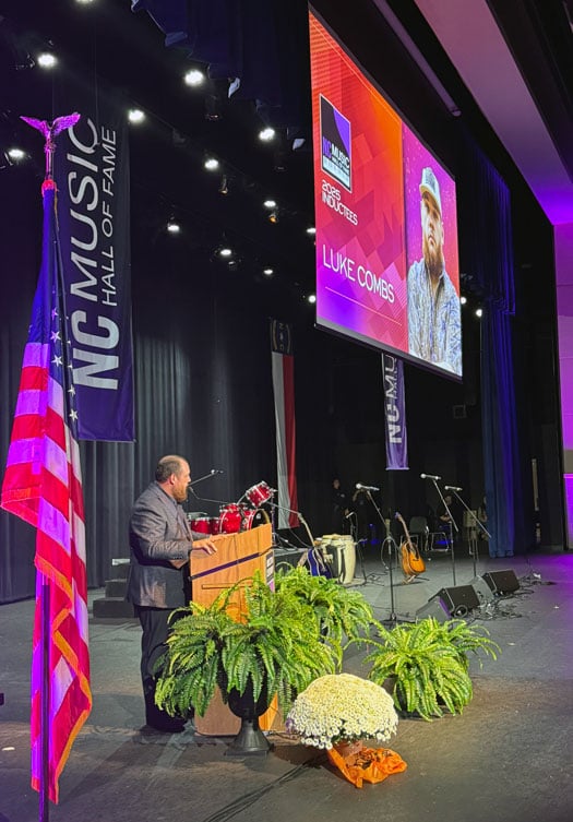 This is an image of 2025 NC Music Hall of Fame inductee Luke Combs during his acceptance speech.